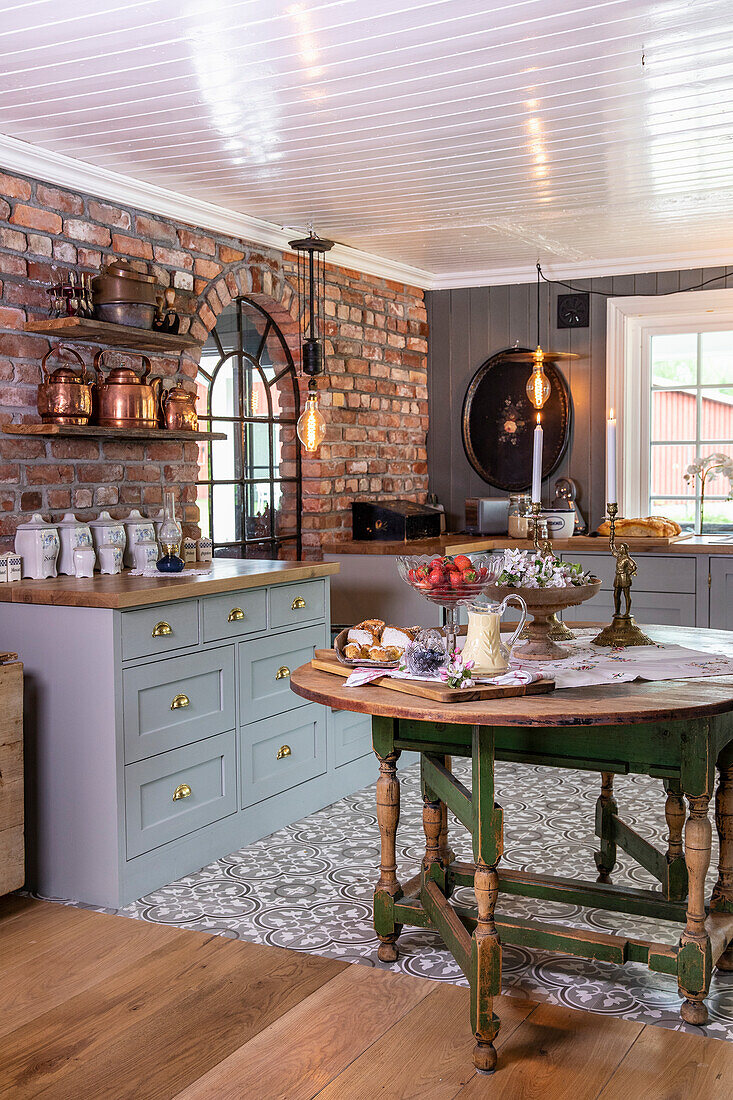 Country-style kitchen with brick and wooden furniture