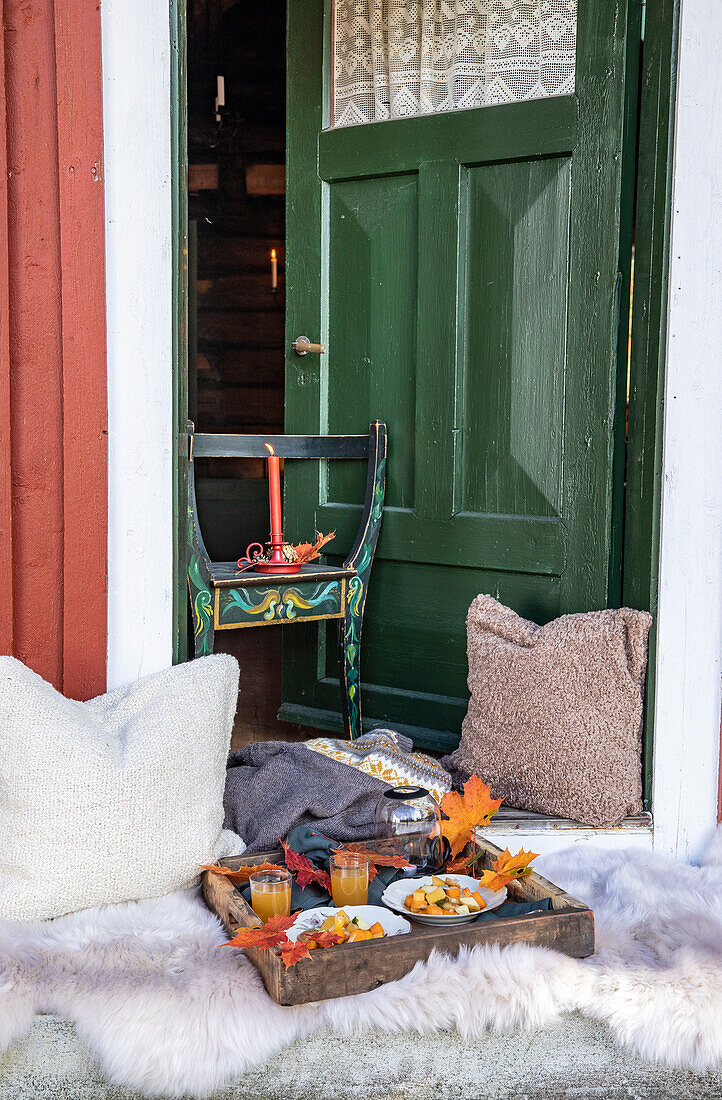 Autumnal decoration in front of a green door