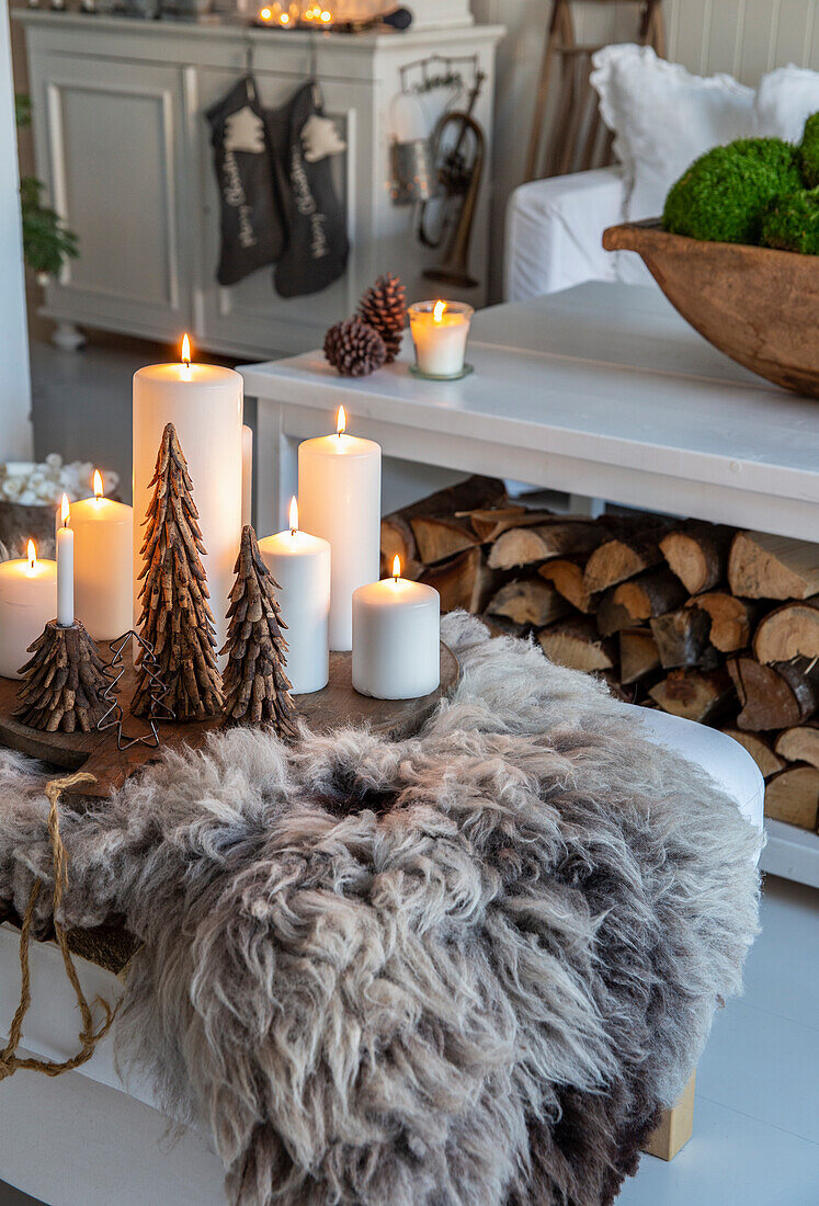 Christmas decorations with candles and fur in the living room