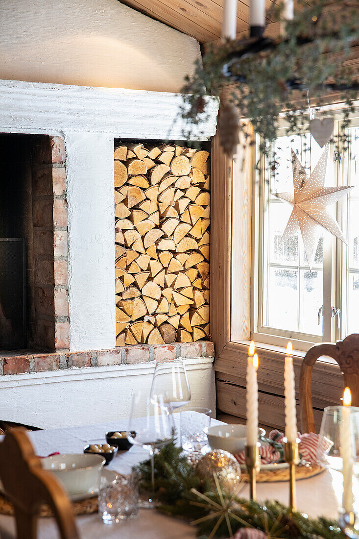 Rustic dining room, Christmas table decorations, fireplace and firewood