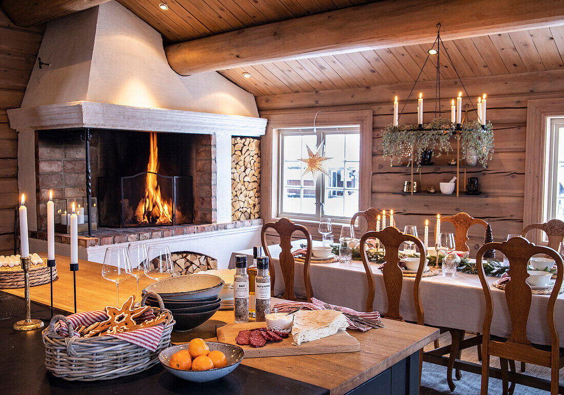 Cozy country-style dining area with open fireplace and rustic wooden elements