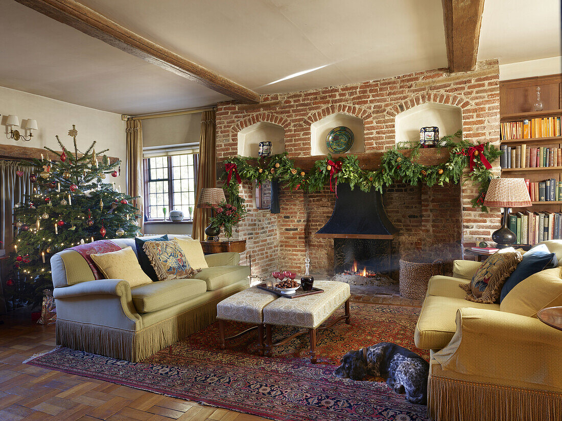 Rustic living room with fireplace and Christmas tree, traditional furnishings