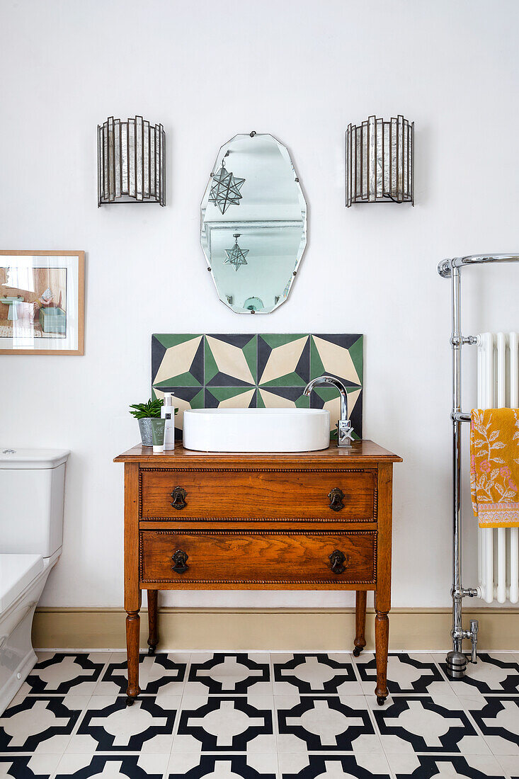 Vintage washbasin with round wash bowl, geometric tiles and wall mirror