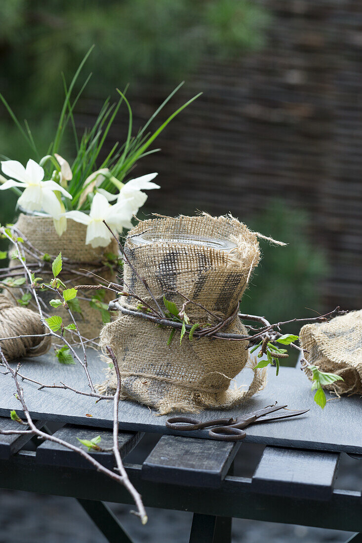 DIY vases made from jars and sacking with daffodils (Narcissus)