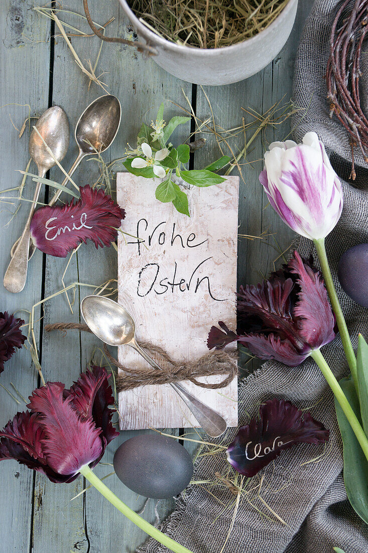 Arrangement with silver cutlery, tulips and Easter egg