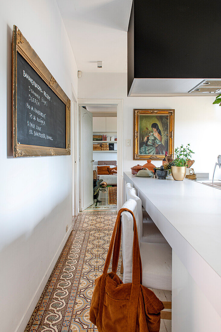 Kitchen with patterned tiled floor and black chalkboard on the wall