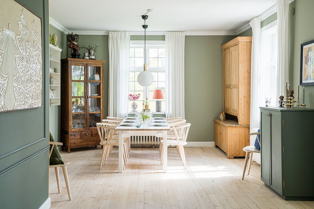 Dining room with wooden furniture and green walls