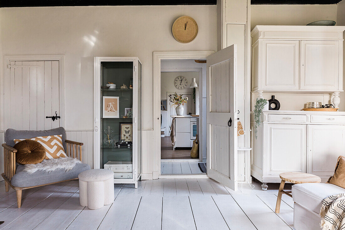 Bright living room with white wooden furniture and display cabinet