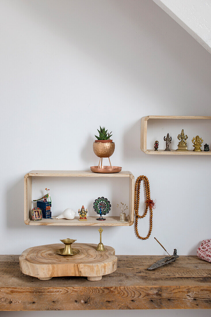 Wall shelves with Buddhist decorative objects