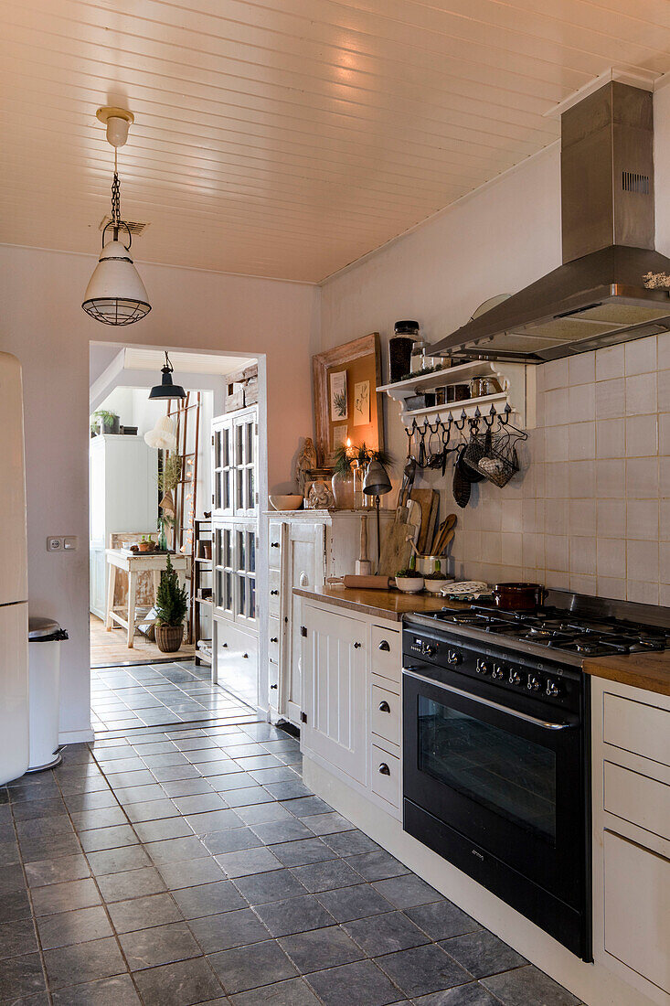 Country kitchen with white fronts and metal hanging lamp