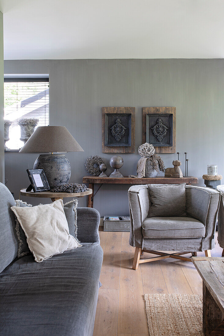 Living room with rustic wooden furniture and decoration in earthy colours