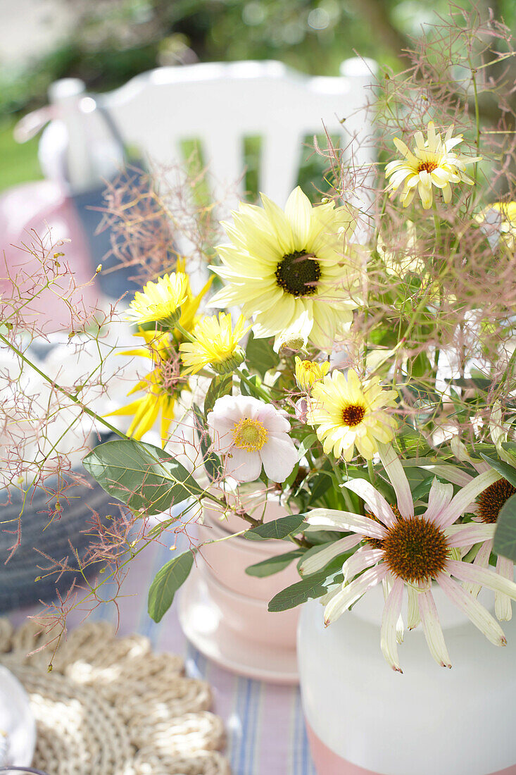 Bouquet of flowers with sunflowers and echinacea on a table in the garden