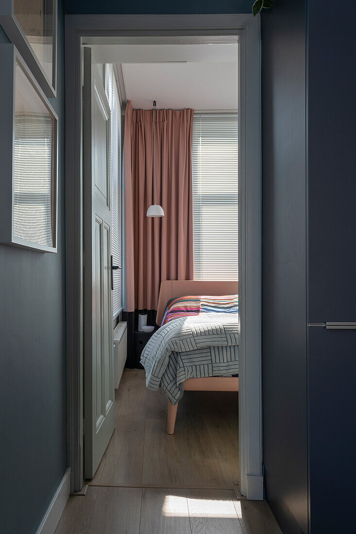 View of bedroom with pink bed and pink curtains