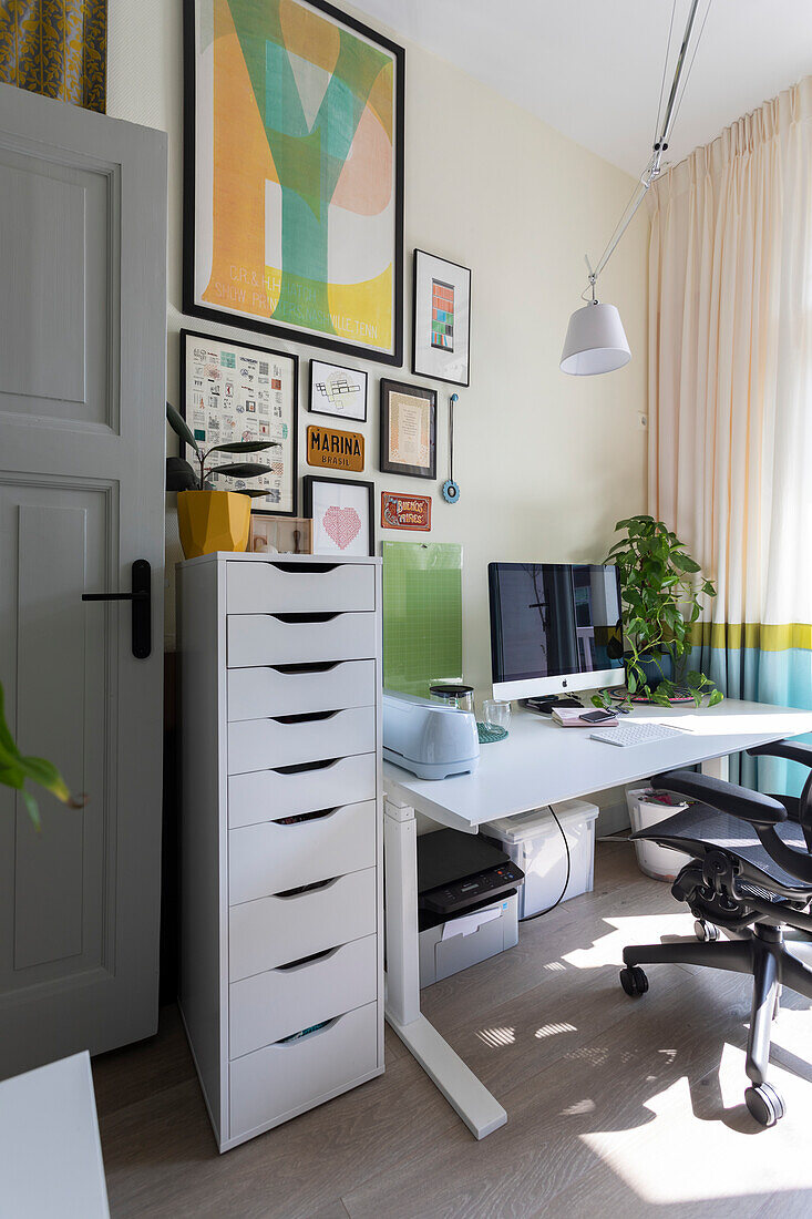 Modern home office with gallery wall and white desk