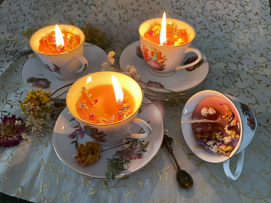 DIY scented candles with dried flowers in tea cups