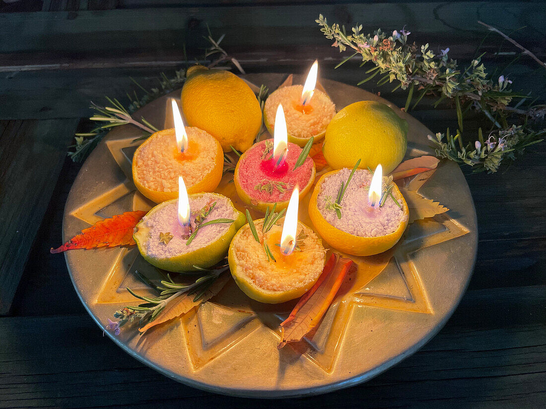 DIY candles with rosemary in lemon peel