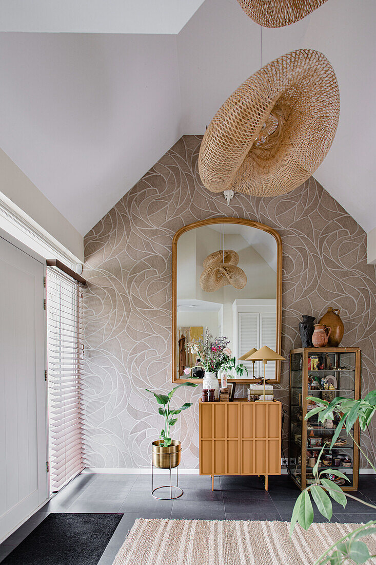 Modern attic room with large mirror and patterned wallpaper