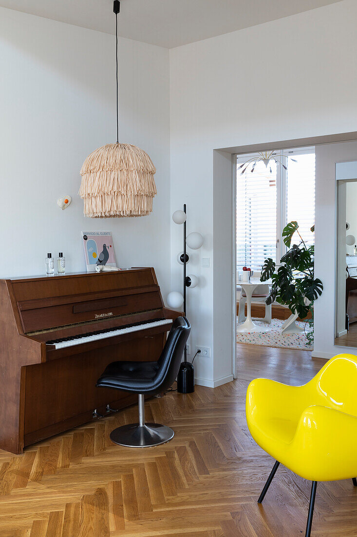 Piano and yellow designer chair in the modern living room