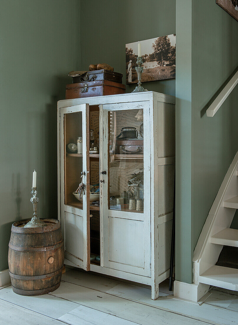 Antique display cabinet and wooden barrel, country style