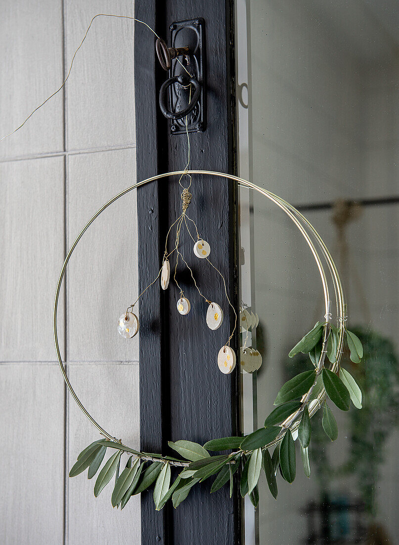 Round metal wreath with olive branches and decorations