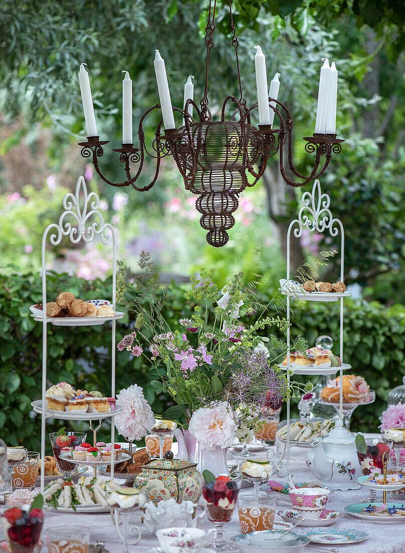 Vintage tea party in the garden with antique chandelier decorations