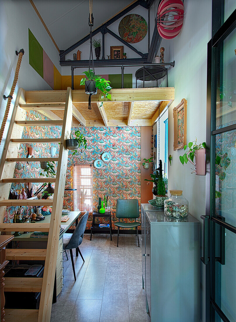 High room with ladder to the gallery, patterned wallpaper and workstation