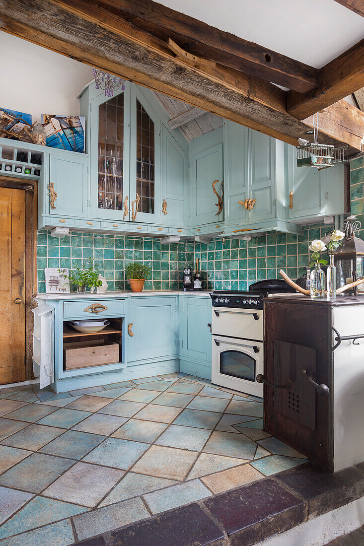 Country-style kitchen with tiles and wooden elements