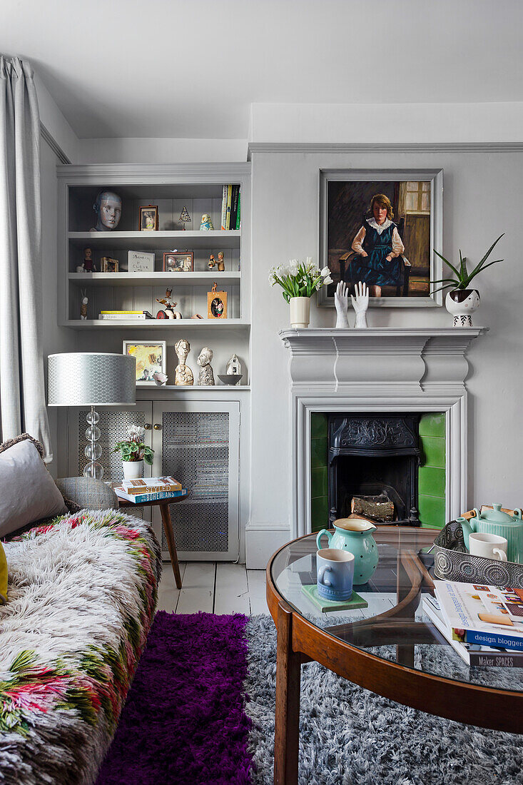 Living room with fireplace, glass coffee table and built-in shelf