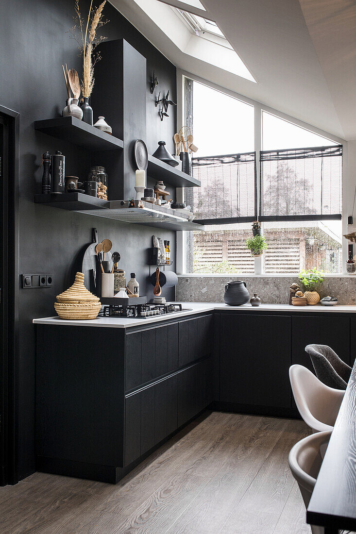 Black kitchen with open shelves and kitchen utensils