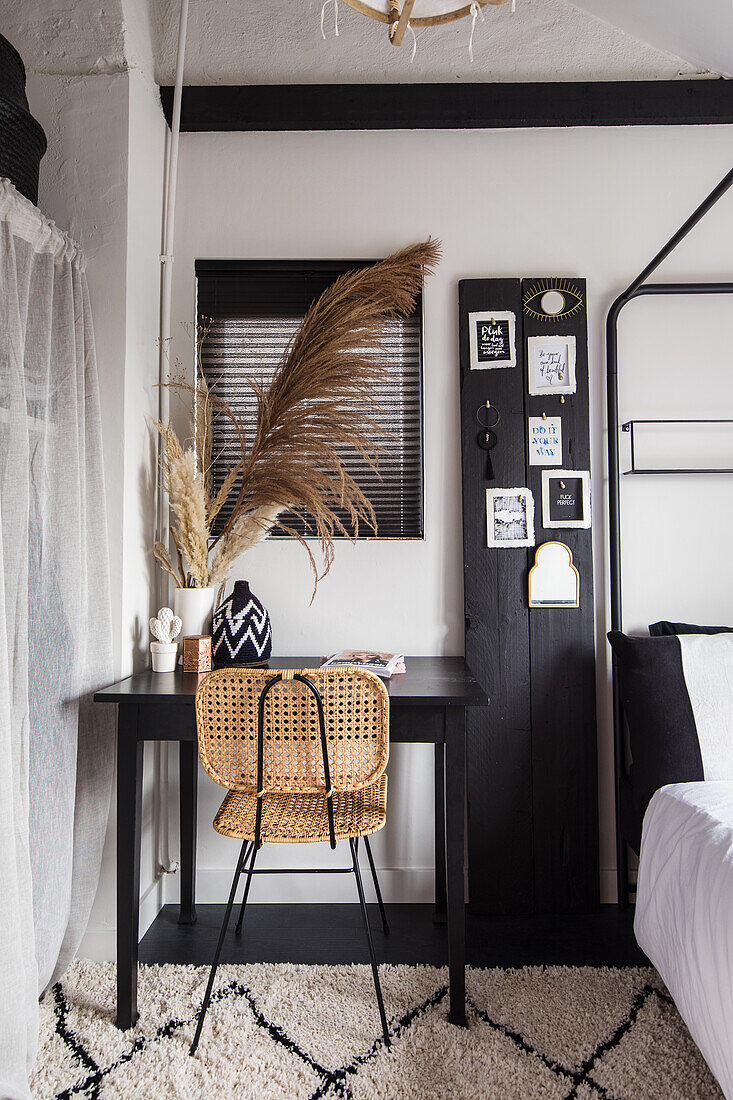 Workplace with rattan chair and decorative grasses in the bedroom