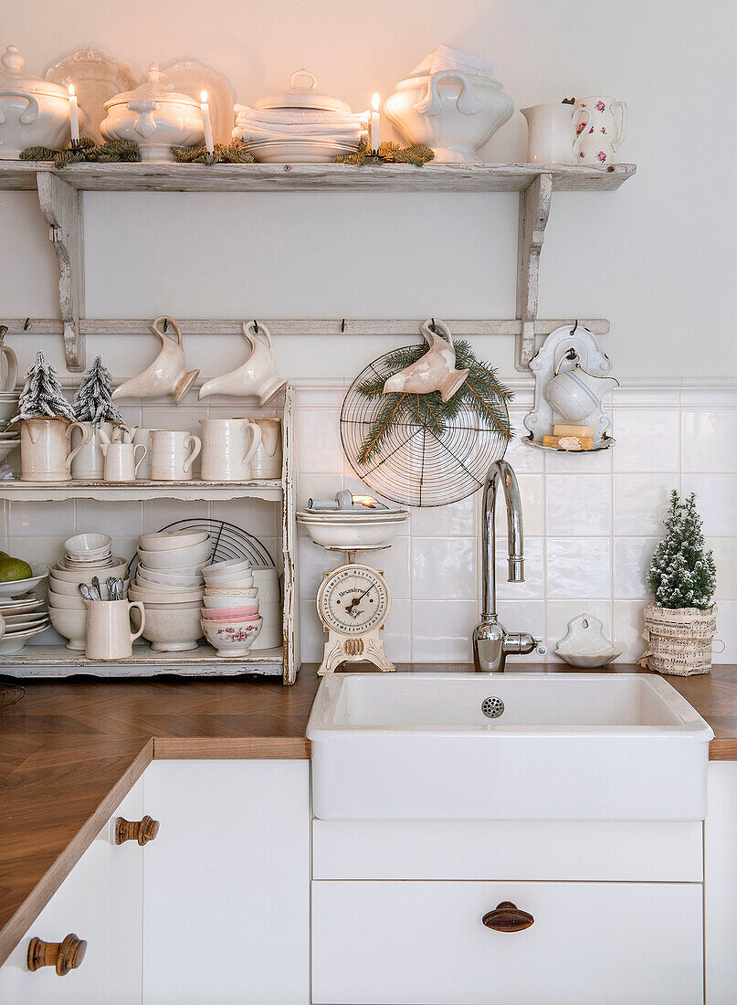 Crockery rack with Christmas decorations above kitchen counter