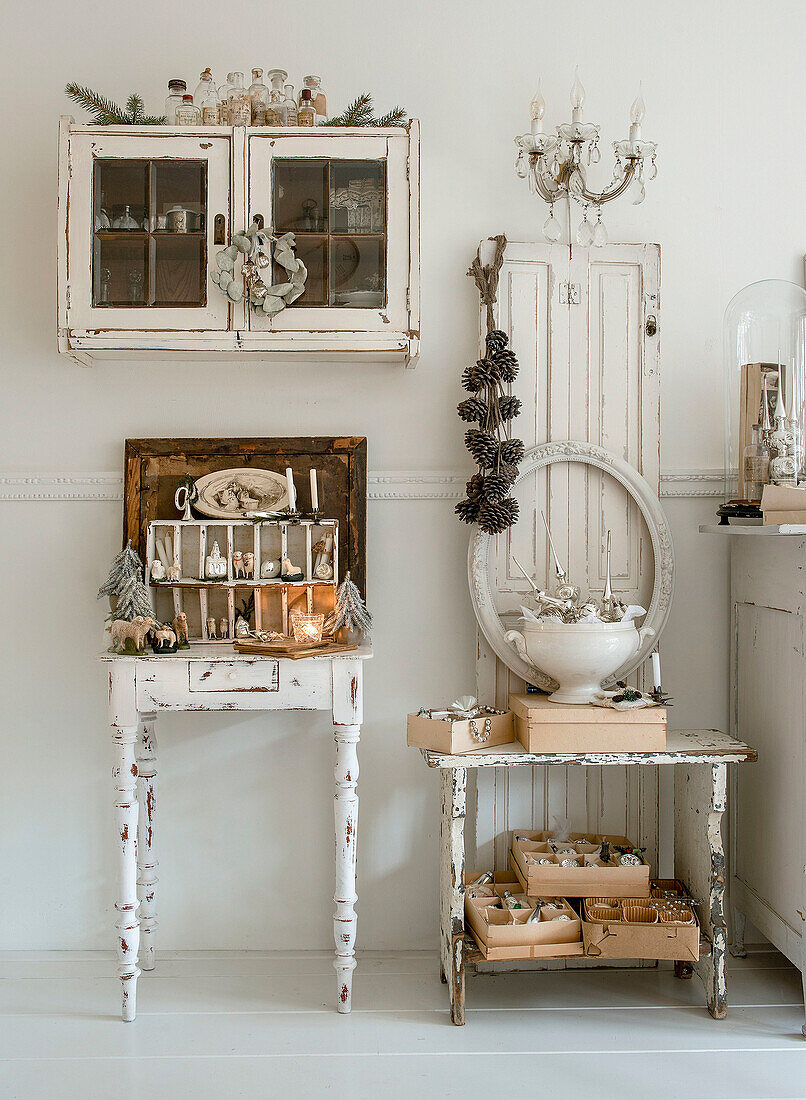 Shabby-style tables and wall cupboard with Christmas decorations