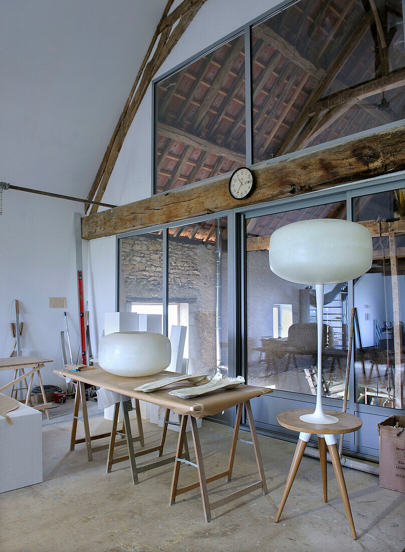 Workshop with woodwork and modern lamps under exposed half-timbering