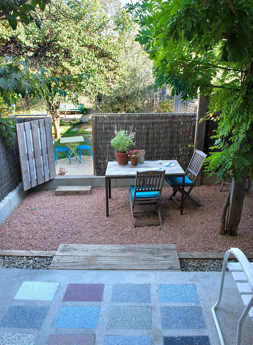 Shady patio area with table and chairs