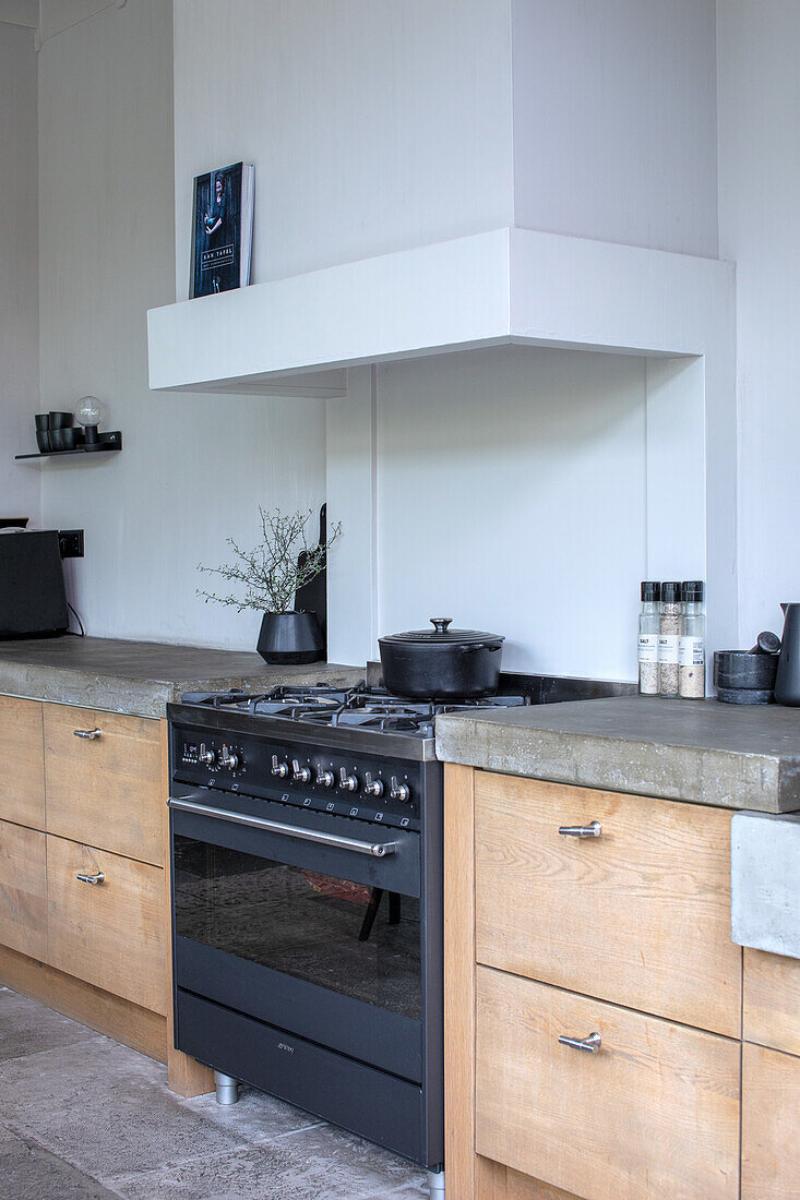 Modern kitchen unit with gas hob and concrete worktop