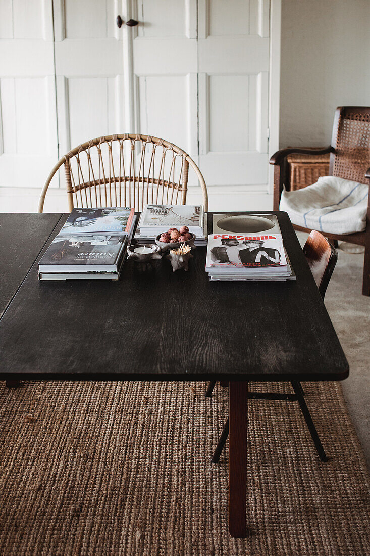 Black dining table with magazines and books