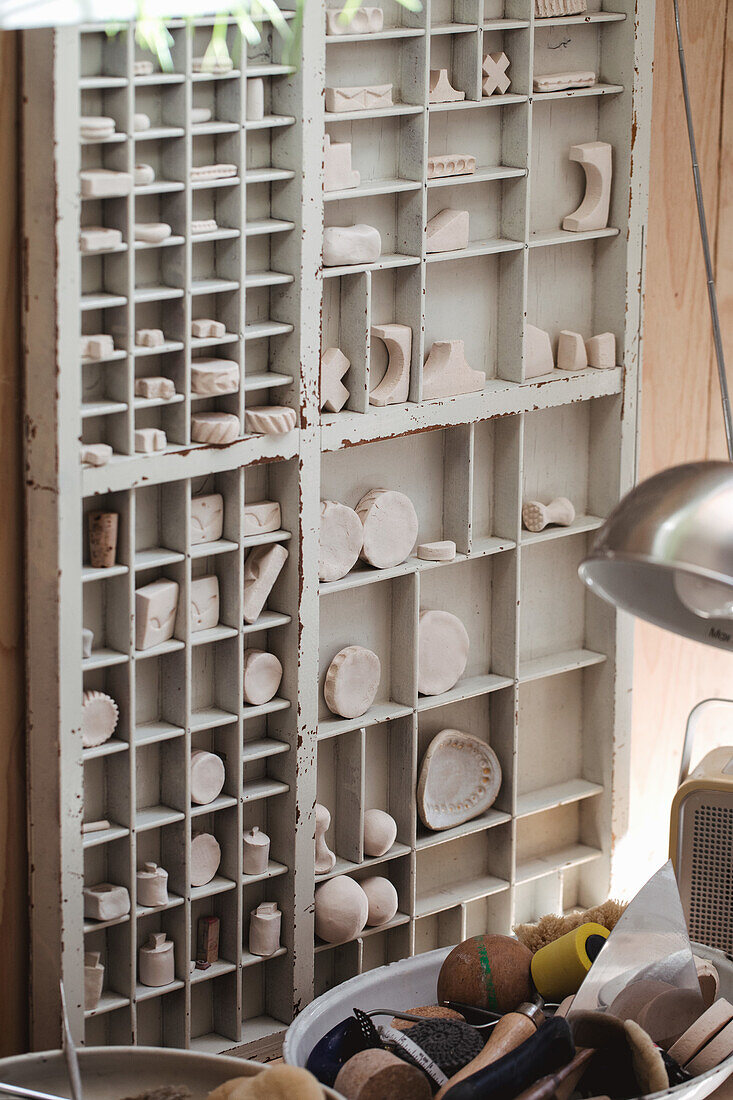 Cabinet with ceramic objects in a pottery workshop