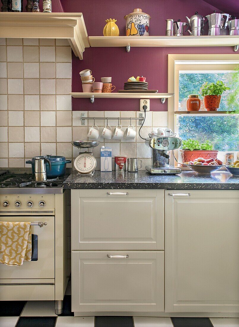 Classic kitchen with purple walls, grey cabinets and black and white checkerboard floor