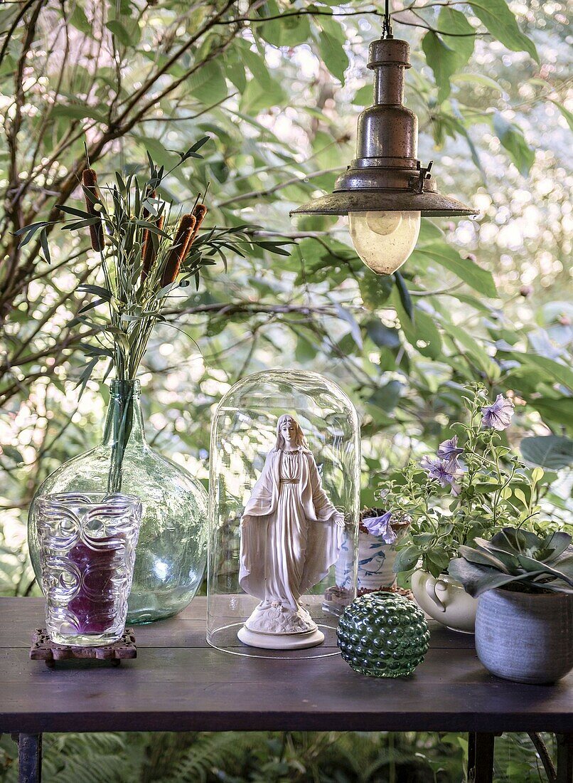 Vintage decoration on a wooden table in the garden under an antique lamp