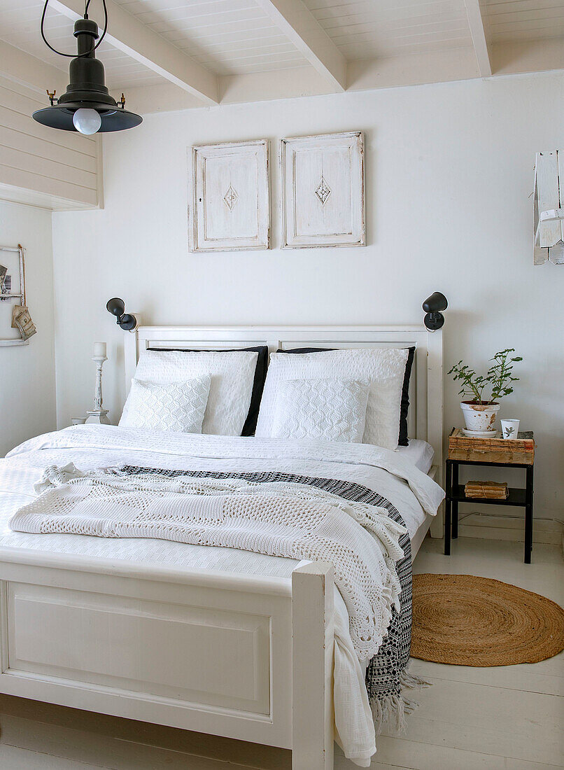 White bedroom with double bed and boho-style bedspread