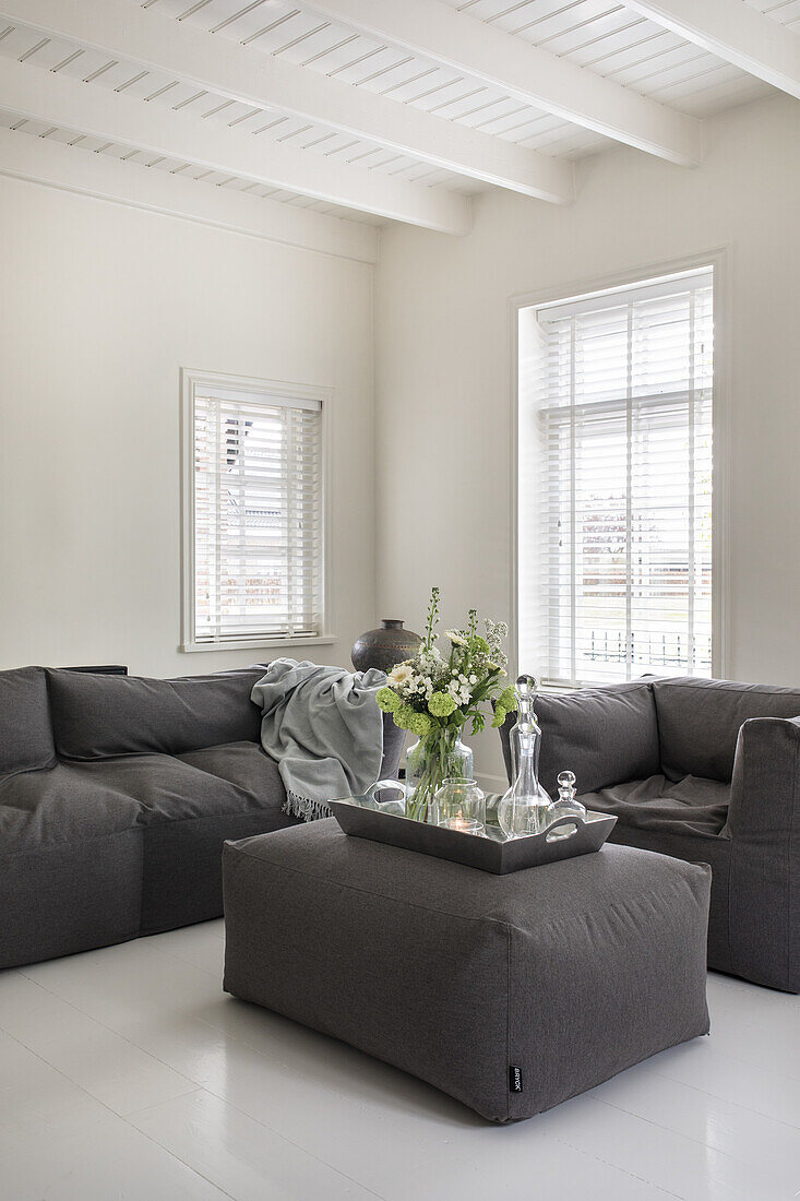 Dark grey sofa in white living room