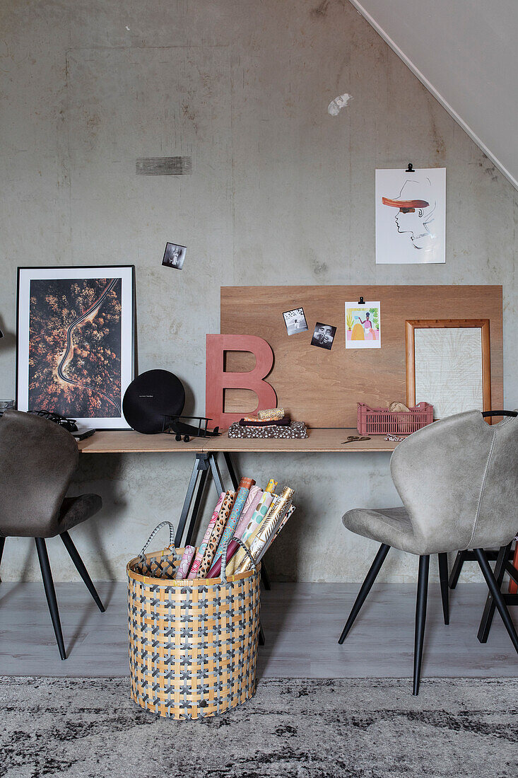 Workplace with pin board and rolls of wrapping paper in a basket