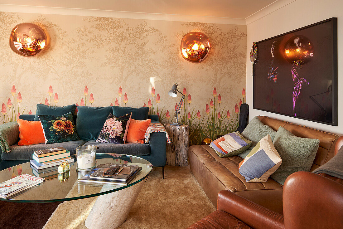 Living room with seating and TV, wallpaper with floral motif on the wall