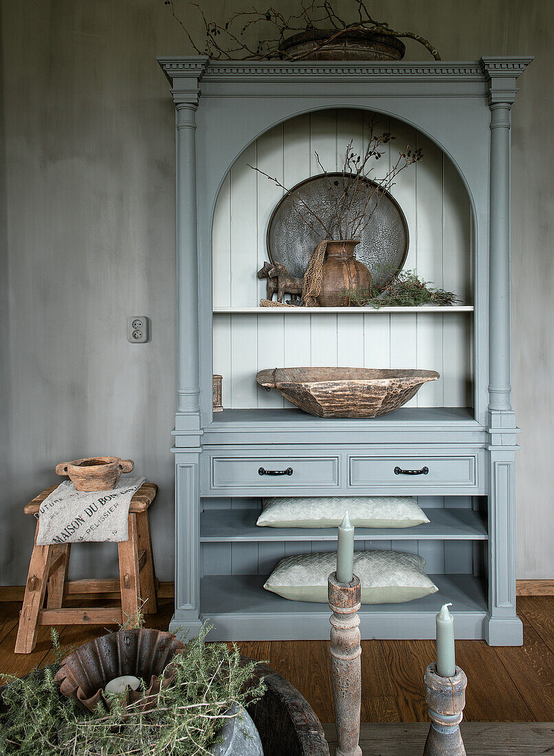 Light grey vintage cupboard with decorations