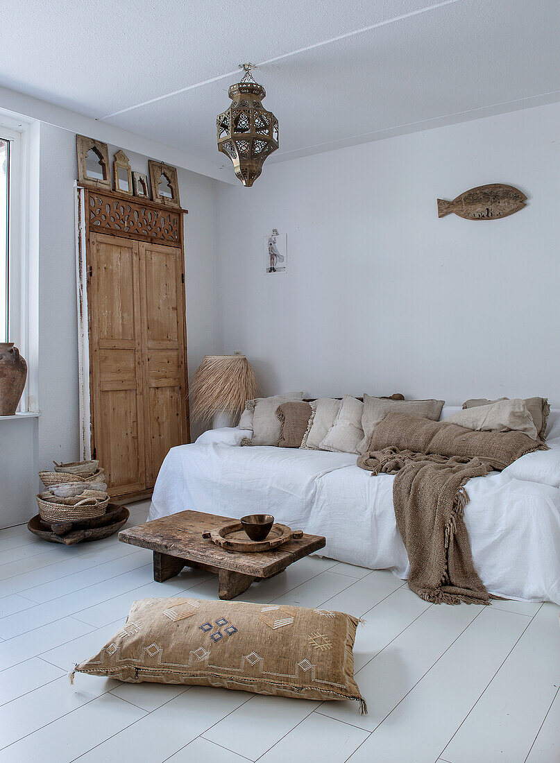 Bright living room with wooden accessories and oriental hanging lamp