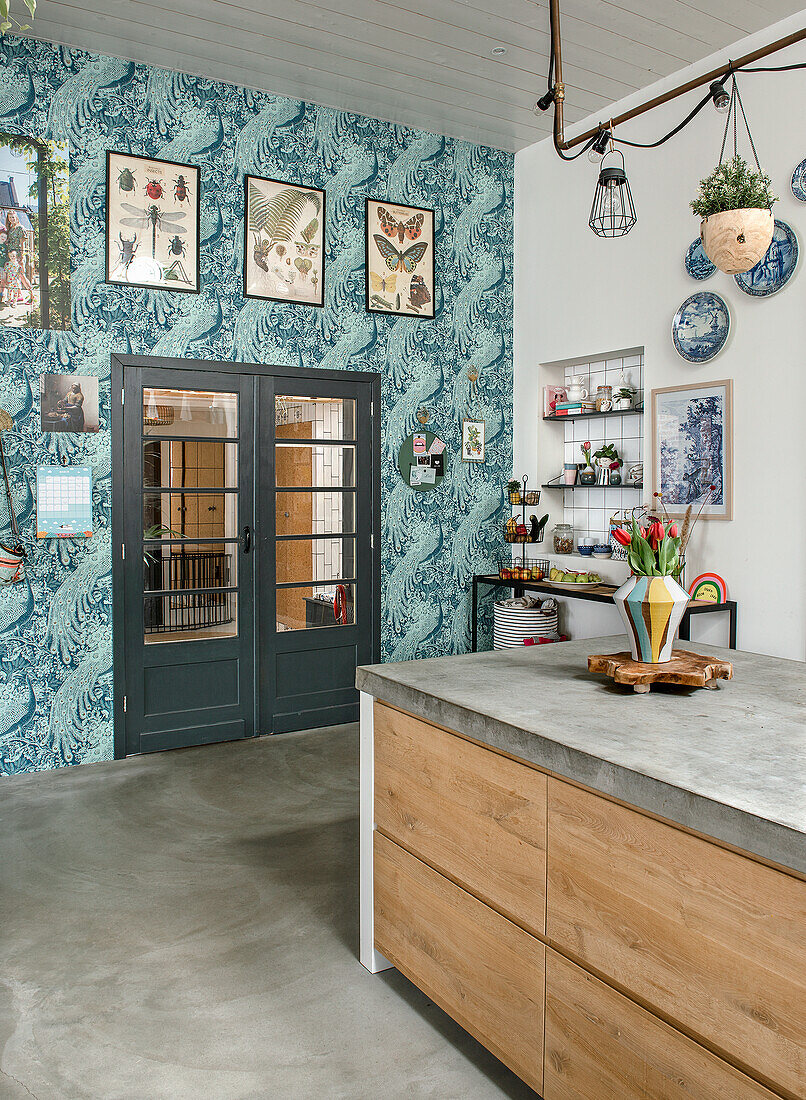 Modern kitchen with island, blue wallpaper and wall decoration