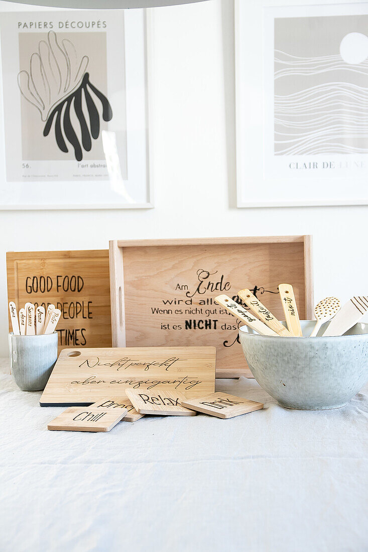 Wooden boards and kitchen utensils with sayings and lettering