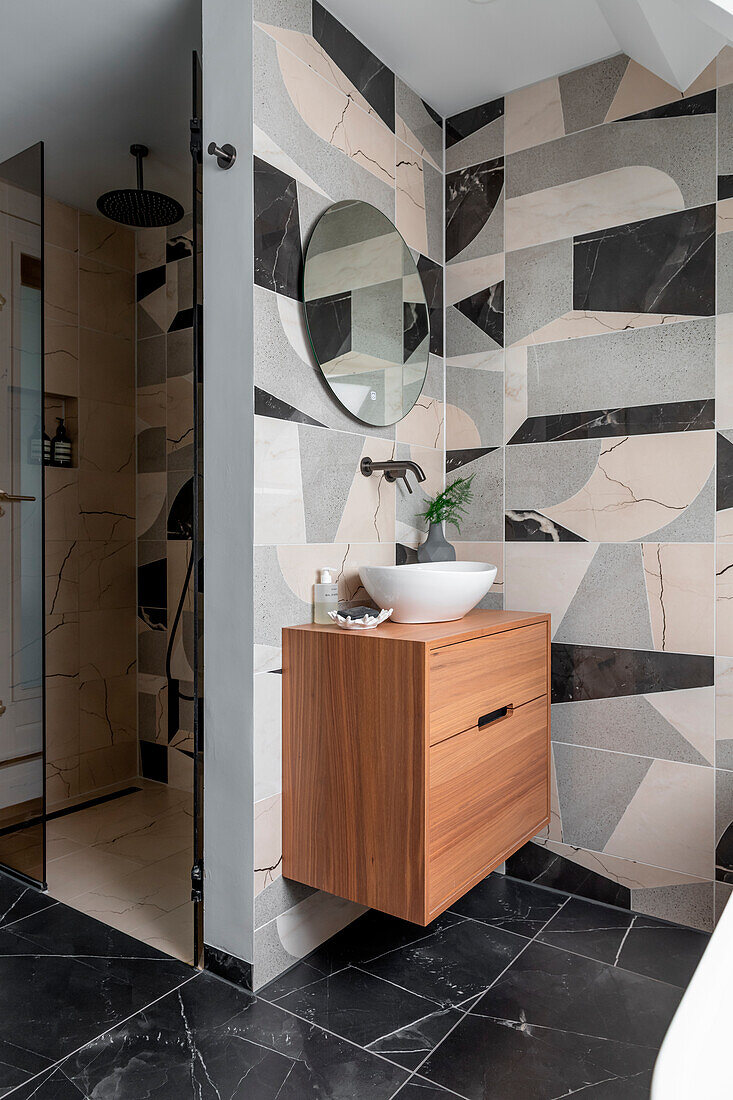 Modern bathroom with modern, geometric tiles and wooden washbasin