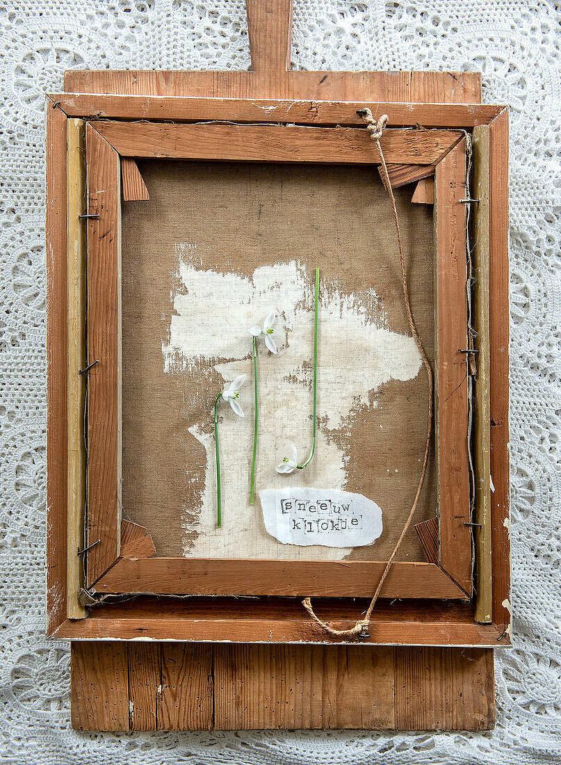 Framed DIY artwork with flowers on a lace background