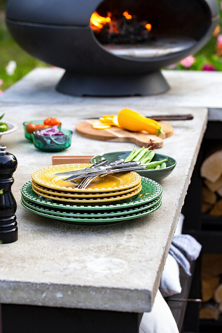 Garden kitchen with pizza stone oven and colourful crockery set